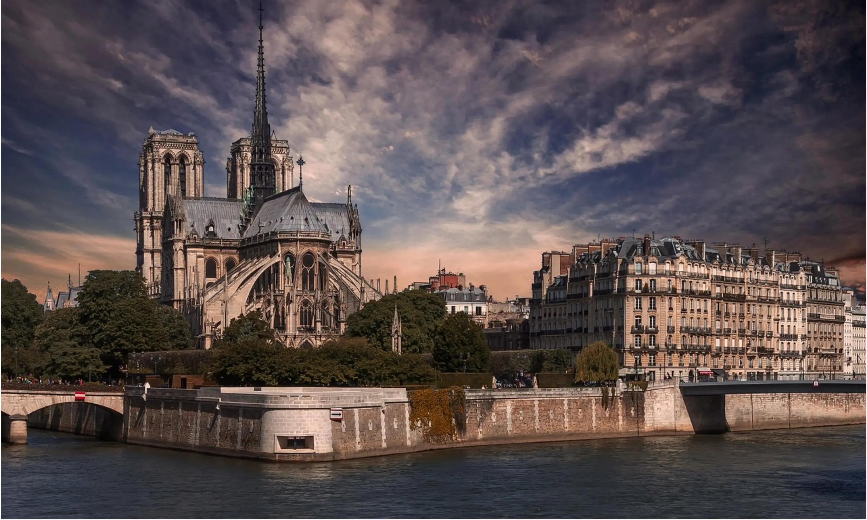A stunning photograph of Notre Dame Cathedral viewed from the Seine River