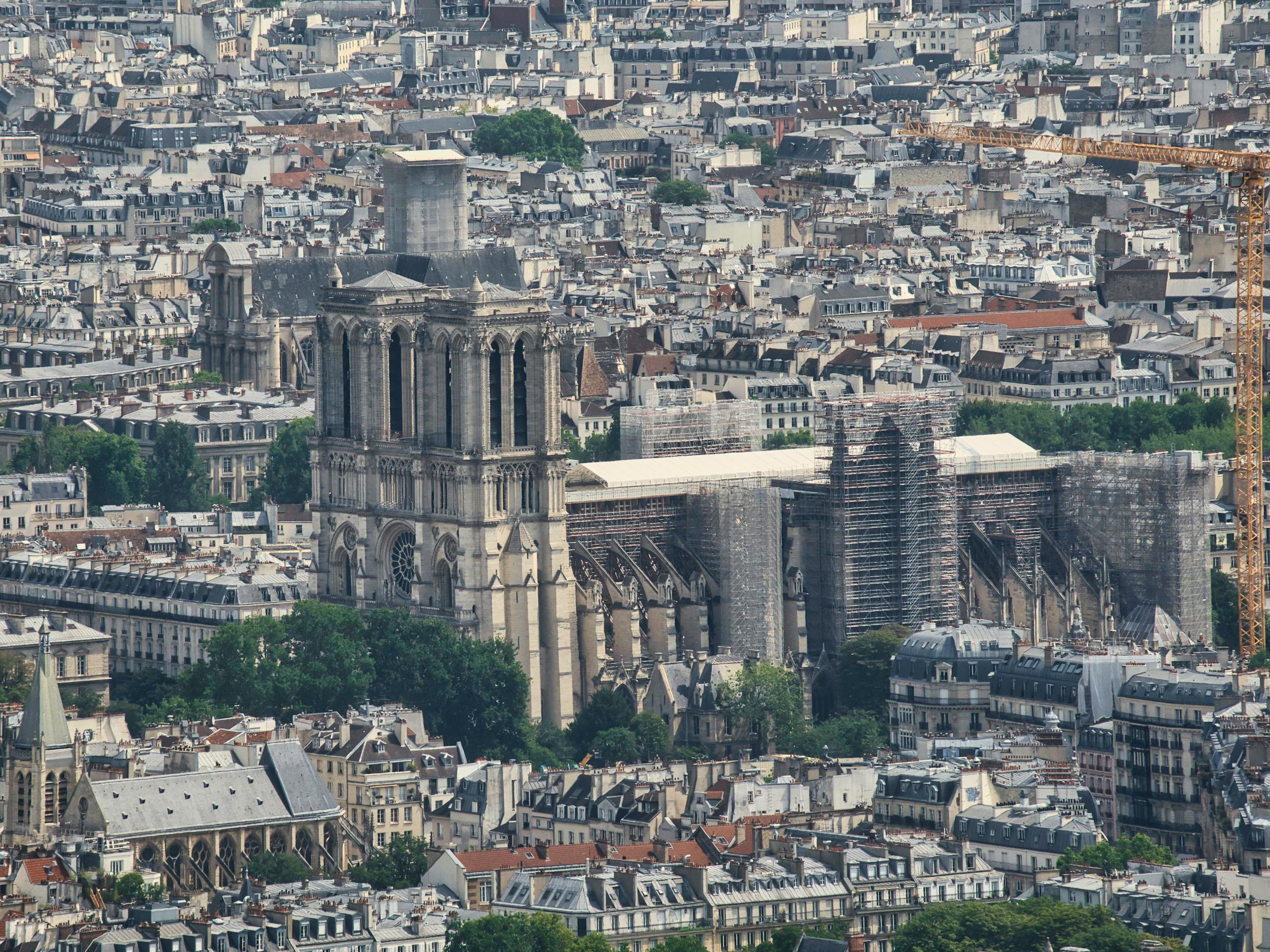 A detailed aerial view of Notre-Dame Cathedral during renovation in Paris, France.