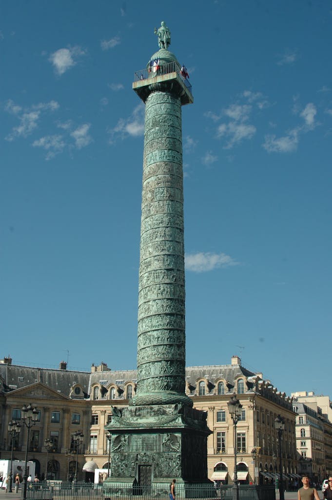 A stunning view of the historic Vendôme Column under a clear blue sky in Paris.