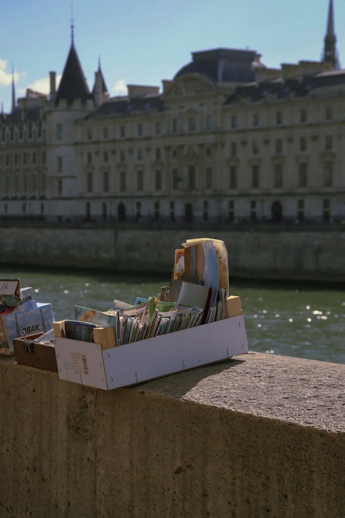 Browse vintage postcards along the Seine River in Paris, capturing the essence of French culture.