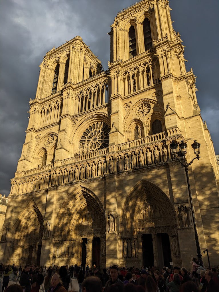Captivating view of the iconic Notre-Dame Cathedral in warm sunlight, Paris.