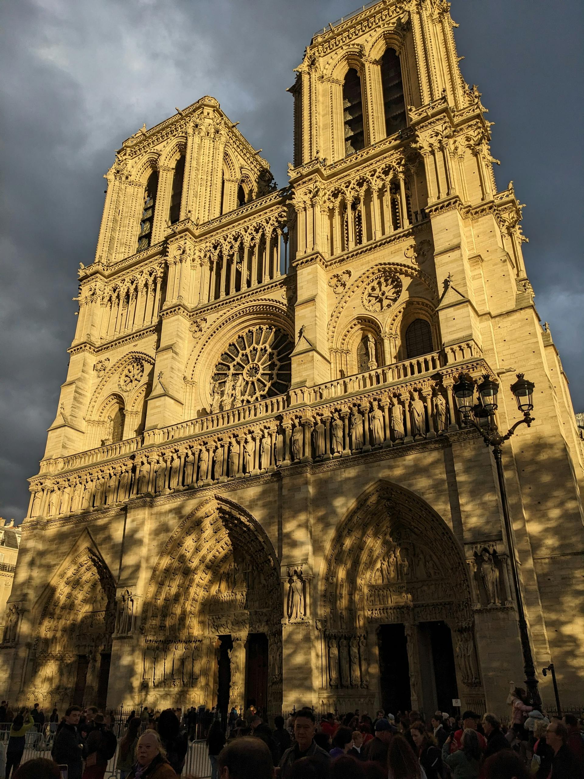 Captivating view of the iconic Notre-Dame Cathedral in warm sunlight, Paris.